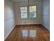 Dining room with hardwood floors, a large window, and neutral wall color at 6419 Edenfield Dr, Lithonia, GA 30058