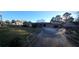 Sprawling stone home with a long driveway and large front yard, set against a blue sky at 6419 Edenfield Dr, Lithonia, GA 30058