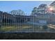Home featuring stone facade, decorative fence, and well-maintained lawn at 6419 Edenfield Dr, Lithonia, GA 30058