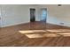 Open living room with hardwood floors and view into other rooms at 6419 Edenfield Dr, Lithonia, GA 30058