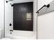 Modern tiled bathroom featuring sleek fixtures, a bathtub, and stylish design at 1074 Peachtree Ne Walk # 115, Atlanta, GA 30309