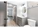 Stylish bathroom featuring a vanity with a modern faucet and a decorative tiled floor, with a view to a bedroom at 1074 Peachtree Ne Walk # 115, Atlanta, GA 30309