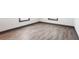 Empty bedroom featuring laminate flooring, baseboard trim, two windows, and electrical outlets on the walls at 1074 Peachtree Ne Walk # 115, Atlanta, GA 30309