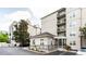 The community's elegant exterior is displayed with multiple stories, balconies, and meticulous landscaping at 1074 Peachtree Ne Walk # 115, Atlanta, GA 30309
