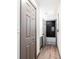 Hallway featuring a view of the bathroom with black and white tiled wall and a laundry cabinet with a door at 1074 Peachtree Ne Walk # 115, Atlanta, GA 30309