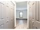 Hallway with wood floors, view of the window and two sides with storage cabinets in neutral colors at 1074 Peachtree Ne Walk # 115, Atlanta, GA 30309