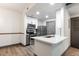Bright kitchen with stainless steel appliances, island, and modern backsplash at 1074 Peachtree Ne Walk # 115, Atlanta, GA 30309