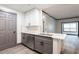 Updated kitchen features gray cabinets, white countertops, and stainless steel appliances at 1074 Peachtree Ne Walk # 115, Atlanta, GA 30309