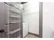 Laundry room with storage shelves and a washing machine for efficient organization at 1074 Peachtree Ne Walk # 115, Atlanta, GA 30309