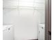 A compact laundry area includes a white washer and dryer, complemented by wire shelving for organized storage at 1074 Peachtree Ne Walk # 115, Atlanta, GA 30309