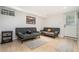 Finished basement featuring two couches, neutral carpeting, and a small table for relaxing and entertaining guests at 1424 Adele Sw Ave, Atlanta, GA 30314
