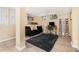 Basement living space with neutral walls, tile flooring, a black sofa, a desk, and natural light from the windows at 1424 Adele Sw Ave, Atlanta, GA 30314
