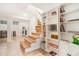 Basement with stairs, tile flooring, washer/dryer, and built-in shelving stocked with books and games at 1424 Adele Sw Ave, Atlanta, GA 30314