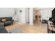 Basement living area showcasing tile flooring, comfortable gray sofas, and access to the outdoors through a door at 1424 Adele Sw Ave, Atlanta, GA 30314
