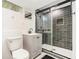 Modern bathroom featuring a glass-enclosed shower with gray subway tile, a floating vanity, and sleek fixtures at 1424 Adele Sw Ave, Atlanta, GA 30314