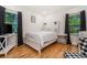 Well-lit bedroom with hardwood floors, white furnishings, and neutral decor at 1424 Adele Sw Ave, Atlanta, GA 30314
