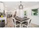 Open dining area features a square table with seating for four and flows into the kitchen at 1424 Adele Sw Ave, Atlanta, GA 30314