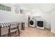 Functional laundry room with side-by-side washer and dryer, folding table, and ample space for organizing laundry at 1424 Adele Sw Ave, Atlanta, GA 30314