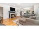 Elegant living room features a cozy fireplace, hardwood floors, and a stylish sectional sofa at 1424 Adele Sw Ave, Atlanta, GA 30314