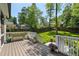 Wooden back deck with white railings overlooks the lush backyard, perfect for relaxation at 2759 Arbor Se Ave, Atlanta, GA 30317