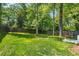 Lush backyard featuring a well-manicured lawn, mature trees, and wooden fencing at 2759 Arbor Se Ave, Atlanta, GA 30317