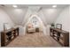 Cozy bonus room with angled ceilings, a comfortable chair, and symmetrical shelving at 2759 Arbor Se Ave, Atlanta, GA 30317