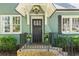 Inviting front porch with black railing, potted flowers, and a decorative door at 2759 Arbor Se Ave, Atlanta, GA 30317