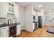 Bright kitchen with white cabinetry, stainless steel appliances, hardwood floors, and a built-in wine cooler at 2759 Arbor Se Ave, Atlanta, GA 30317