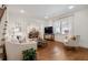 Sunlit living room with hardwood flooring, white sofa, and adjacent dining space at 2759 Arbor Se Ave, Atlanta, GA 30317
