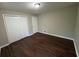 A well-lit bedroom features hardwood floors, neutral paint, a ceiling fan, and a closet at 5183 Mccarter Ct, Stone Mountain, GA 30088