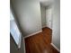 Small room features hardwood flooring, window with blind, neutral paint and a door at 5183 Mccarter Ct, Stone Mountain, GA 30088