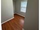 Small room features hardwood flooring, window with blind, and neutral paint at 5183 Mccarter Ct, Stone Mountain, GA 30088