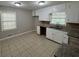 Bright kitchen with white cabinetry, ample countertop space, and ceramic tile flooring at 5183 Mccarter Ct, Stone Mountain, GA 30088