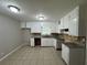 Kitchen featuring granite countertops, white cabinets and ceramic tile flooring at 5183 Mccarter Ct, Stone Mountain, GA 30088