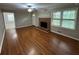 Inviting living room boasting a brick fireplace, hardwood flooring, and neutral paint at 5183 Mccarter Ct, Stone Mountain, GA 30088