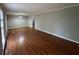 A spacious living room with freshly painted walls and gleaming hardwood floors at 5183 Mccarter Ct, Stone Mountain, GA 30088