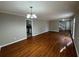 Bright living room features hardwood floors, a modern light fixture and neutral paint at 5183 Mccarter Ct, Stone Mountain, GA 30088