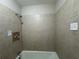 Tiled shower with neutral colors and updated fixtures at 5183 Mccarter Ct, Stone Mountain, GA 30088