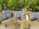 Aerial view of a home showcasing its well-maintained landscaping and mature trees, providing a private setting at 710 Bentgrass Ct, Dacula, GA 30019