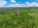 Lush greenery surrounds a residential neighborhood under a sunny sky, offering privacy and a beautiful natural setting at 3544 Candytuft Run, Auburn, GA 30011