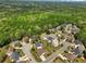 Aerial view showcasing a neighborhood adjacent to a lush green forest at 3544 Candytuft Run, Auburn, GA 30011