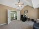 Spacious bedroom featuring neutral colors, carpet flooring, and a partial view of the upstairs hallway at 3544 Candytuft Run, Auburn, GA 30011