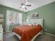 Comfortable bedroom featuring neutral tones, a ceiling fan, and natural light from the window at 3544 Candytuft Run, Auburn, GA 30011