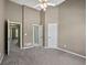 Carpeted bedroom with doors leading to two closets and to an adjoining room at 3544 Candytuft Run, Auburn, GA 30011