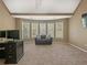 Spacious bedroom boasts large windows and a comfortable sitting area. Neutral carpet and tan walls create a cozy space at 3544 Candytuft Run, Auburn, GA 30011