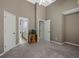 Large bedroom with gray carpet, tall ceilings, and multiple doorways at 3544 Candytuft Run, Auburn, GA 30011