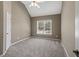 Carpeted bedroom with vaulted ceiling, a window, and a closet and door on the left at 3544 Candytuft Run, Auburn, GA 30011