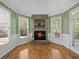 Bright breakfast nook with brick fireplace, wainscoting, and windows offering scenic views at 3544 Candytuft Run, Auburn, GA 30011