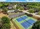 Aerial shot showcasing community amenities: tennis courts, pool, playground, and a parking area at 3544 Candytuft Run, Auburn, GA 30011