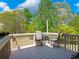 Wooden deck with outdoor seating offers serene views of the fenced backyard at 3544 Candytuft Run, Auburn, GA 30011